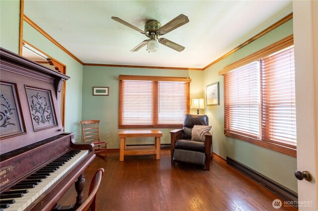 50 Blackberry St, Forks, WA 98331 - sitting room with baseboard heating, ornamental molding, ceiling fan, and dark wood finished floors