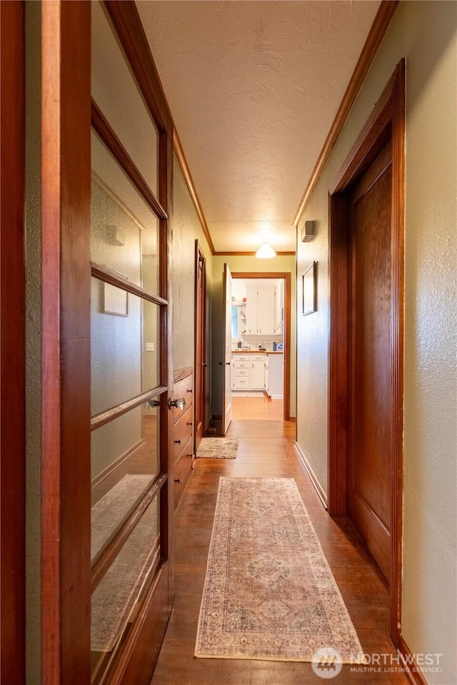 50 Blackberry St, Forks, WA 98331 - hallway with dark wood finished floors, crown molding, and a textured ceiling