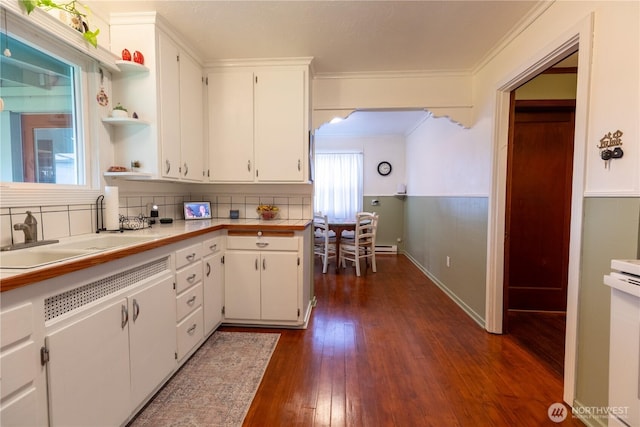 50 Blackberry St, Forks, WA 98331 - kitchen with open shelves, light countertops, ornamental molding, white cabinets, and dark wood-style floors