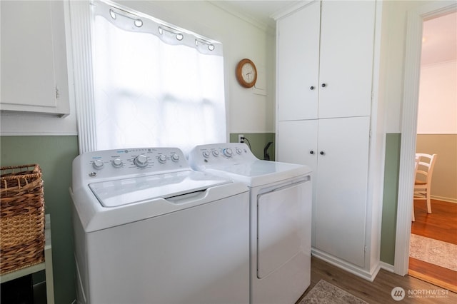50 Blackberry St, Forks, WA 98331 - laundry room with cabinet space, washer and dryer, wood finished floors, and ornamental molding