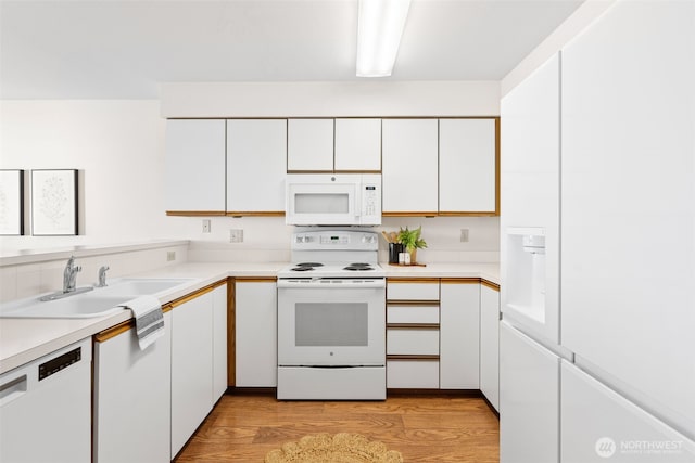 8026 Birch Bay Dr Unit 216, Blaine, WA 98230 - kitchen featuring white appliances, white cabinetry, light countertops, and light wood-type flooring
