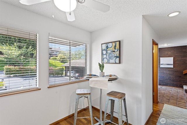 10742 Glen Acres Dr S Unit T-27, Seattle, WA 98168 - dining area with a textured ceiling, wood finished floors, and a ceiling fan