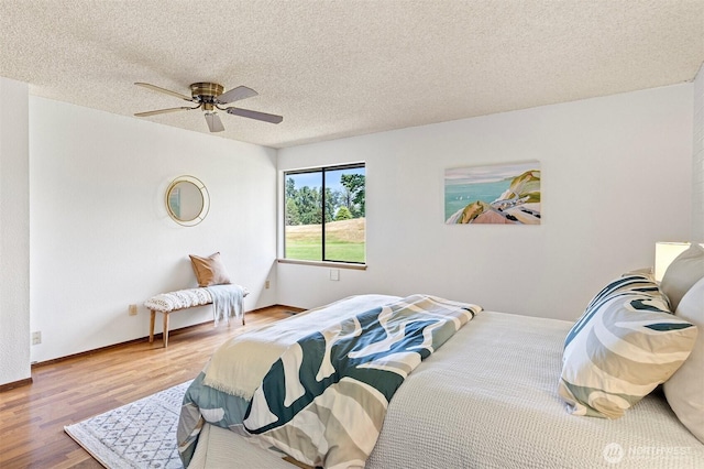 10742 Glen Acres Dr S Unit T-27, Seattle, WA 98168 - bedroom featuring wood finished floors, a textured ceiling, and ceiling fan