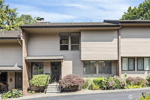 10742 Glen Acres Dr S Unit T-27, Seattle, WA 98168 - view of front facade featuring a chimney