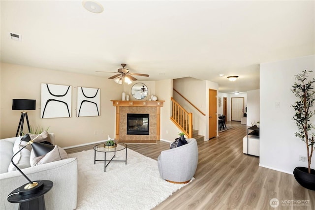 21721 SE 299th Way, Kent, WA 98042 - living area with stairs, a fireplace, light wood-type flooring, and a ceiling fan