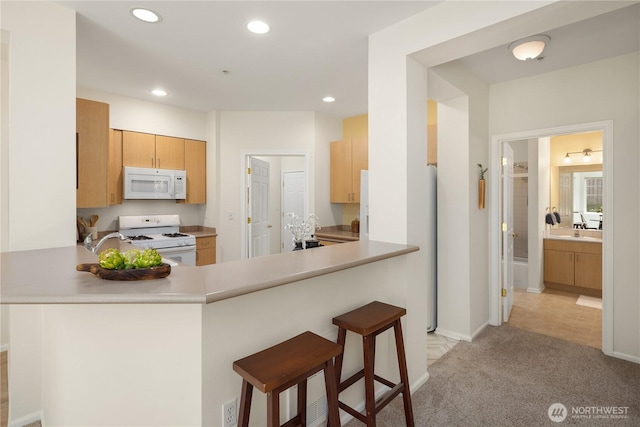 5100 Talbot Pl S Unit F, Renton, WA 98055 - kitchen with white appliances, recessed lighting, a peninsula, and light countertops