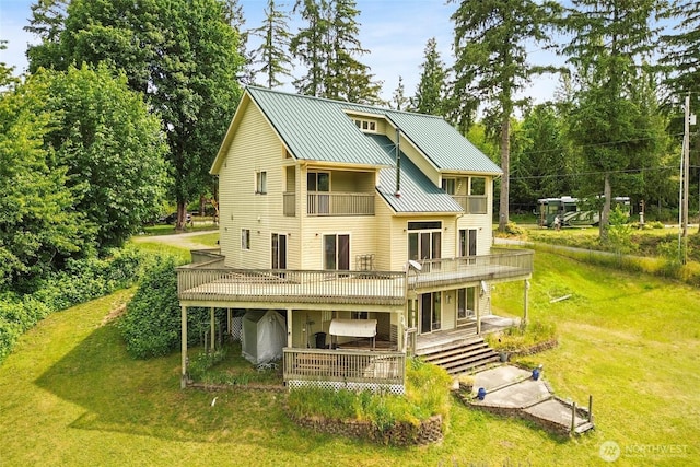 8120 Gordon Rd, Concrete, WA 98237 - rear view of property featuring a deck, a yard, metal roof, a standing seam roof, and a balcony