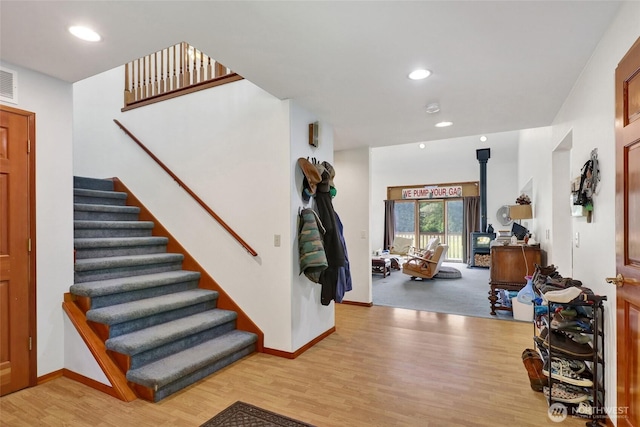 8120 Gordon Rd, Concrete, WA 98237 - entrance foyer with light wood-style floors, stairs, baseboards, recessed lighting, and a wood stove