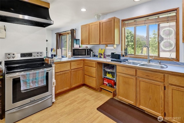 8120 Gordon Rd, Concrete, WA 98237 - kitchen with stainless steel appliances, range hood, a sink, light countertops, and light wood-type flooring