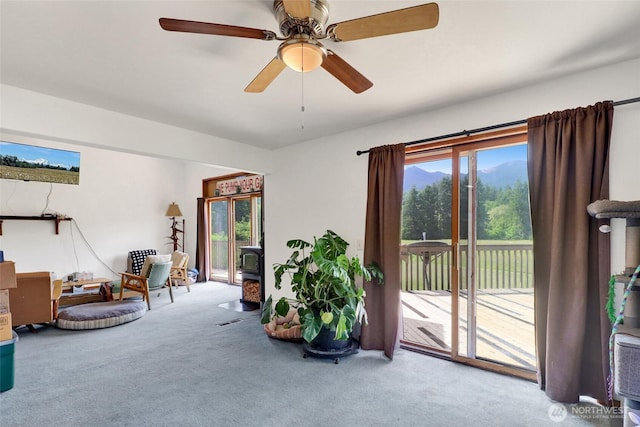 8120 Gordon Rd, Concrete, WA 98237 - sitting room with a wood stove, carpet floors, and ceiling fan