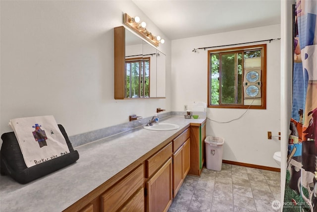 8120 Gordon Rd, Concrete, WA 98237 - full bathroom featuring vanity, healthy amount of natural light, baseboards, and toilet