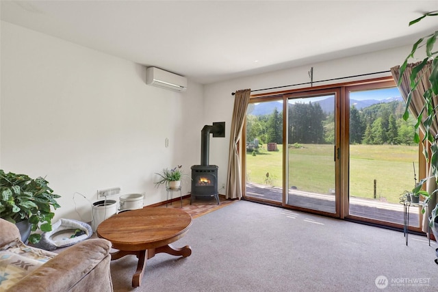 8120 Gordon Rd, Concrete, WA 98237 - living area with a wall mounted AC, a wood stove, and carpet flooring