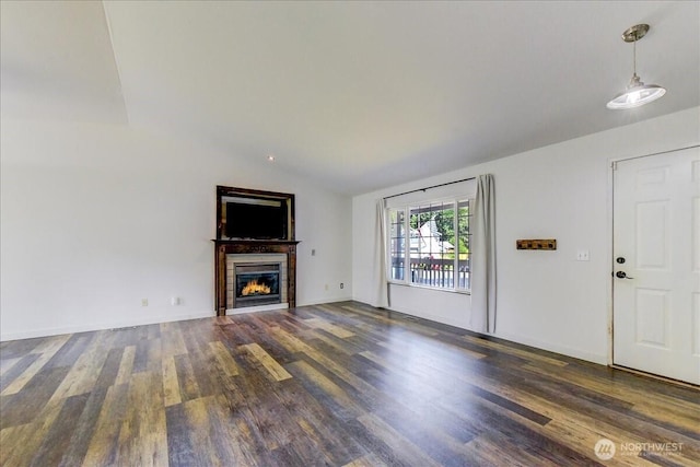 7116 200th Street Ct E, Spanaway, WA 98387 - unfurnished living room with lofted ceiling, wood finished floors, and a lit fireplace
