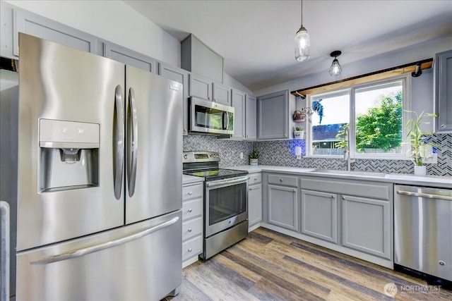 7116 200th Street Ct E, Spanaway, WA 98387 - kitchen featuring stainless steel appliances, gray cabinetry, backsplash, and light countertops