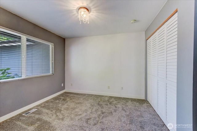 7116 200th Street Ct E, Spanaway, WA 98387 - unfurnished bedroom featuring carpet floors, a closet, and a chandelier