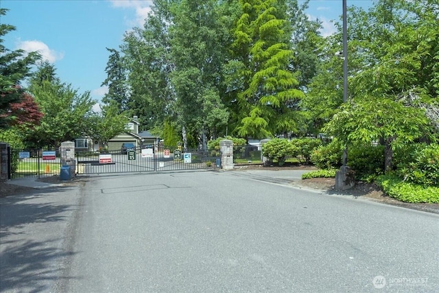 7116 200th Street Ct E, Spanaway, WA 98387 - view of asphalt street featuring a gate, a gated entry, and curbs