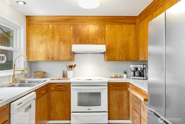 6151 S 125th St, Seattle, WA 98178 - kitchen featuring white appliances, under cabinet range hood, light countertops, and brown cabinets