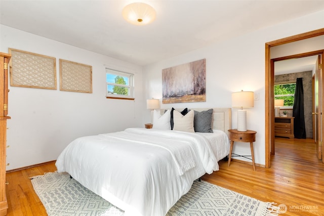 6151 S 125th St, Seattle, WA 98178 - bedroom with multiple windows and light wood-style floors