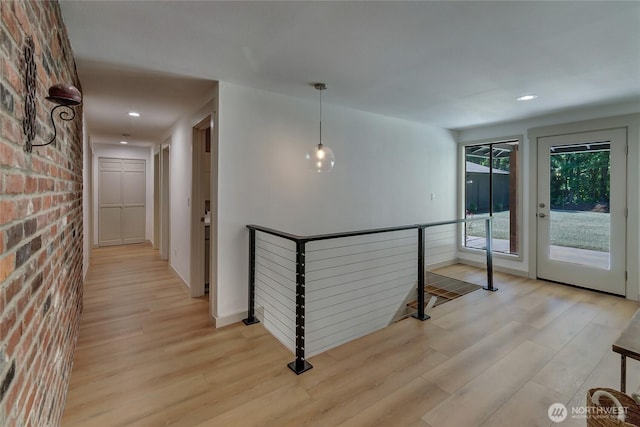 3327 170th Ave E, Lake Tapps, WA 98391 - corridor featuring an upstairs landing, light wood finished floors, brick wall, and recessed lighting