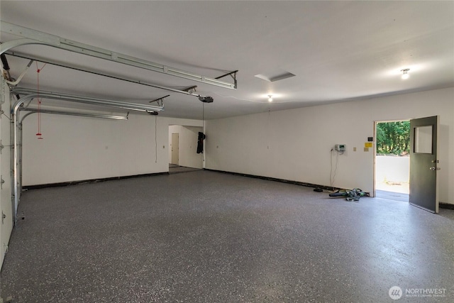 3327 170th Ave E, Lake Tapps, WA 98391 - garage featuring a garage door opener and baseboards
