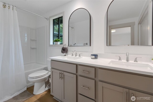 3327 170th Ave E, Lake Tapps, WA 98391 - bathroom featuring double vanity, shower / tub combo, and wood finished floors