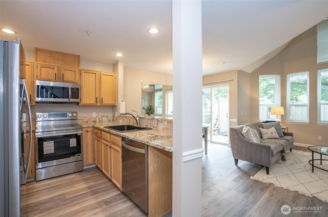 6711 S 239th Pl Unit A103, Kent, WA 98032 - kitchen with stainless steel appliances, light wood-style flooring, open floor plan, light stone counters, and recessed lighting