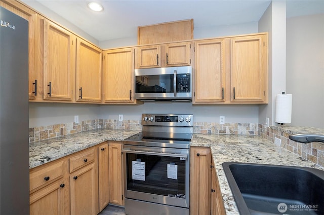 6711 S 239th Pl Unit A103, Kent, WA 98032 - kitchen featuring appliances with stainless steel finishes, light stone counters, light brown cabinets, and recessed lighting