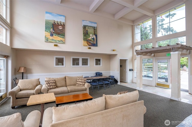 6711 S 239th Pl Unit A103, Kent, WA 98032 - carpeted living area featuring a towering ceiling, beamed ceiling, coffered ceiling, and wainscoting