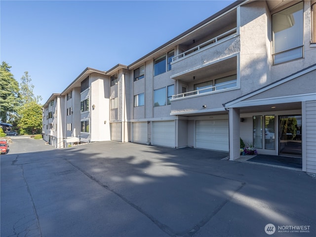 1113 5th Ave S Unit 107, Edmonds, WA 98020 - view of building exterior featuring an attached garage and driveway