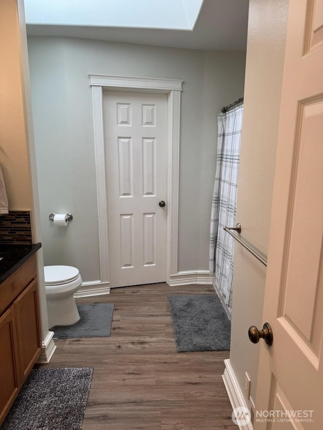 1517 Chilton Rd, Aberdeen, WA 98520 - bathroom featuring vanity, wood finished floors, and a skylight