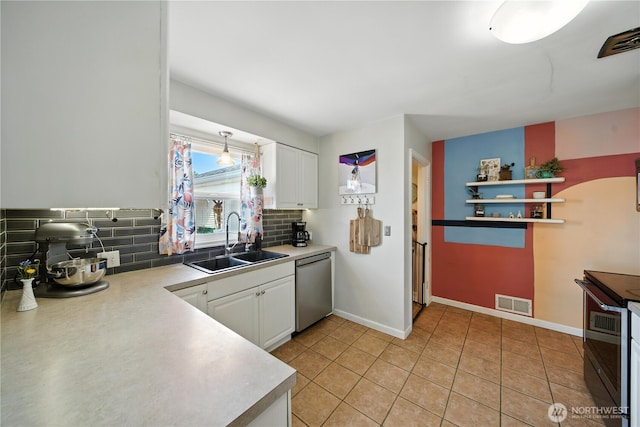 2348 Rainier St, Walla Walla, WA 99362 - kitchen featuring stainless steel appliances, backsplash, white cabinets, and light countertops