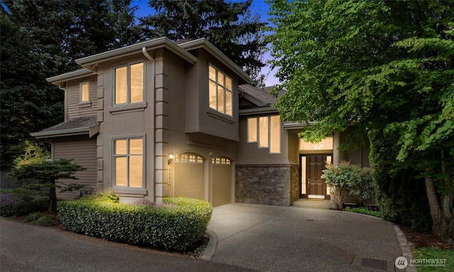 8407 SE 69th Pl, Mercer Island, WA 98040 - view of front of house with concrete driveway, a garage, and stone siding