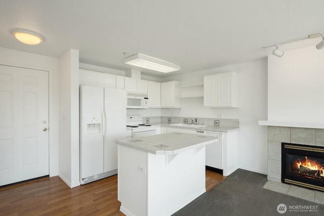 910 34th St Unit 302, Anacortes, WA 98221 - kitchen featuring white appliances, open shelves, a kitchen island, white cabinetry, and tile countertops