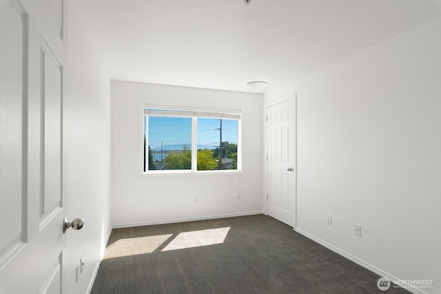 910 34th St Unit 302, Anacortes, WA 98221 - empty room featuring dark carpet and baseboards