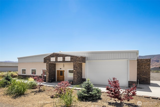 431 Airport Way SW, Mattawa, WA 99349 - view of front of property with a garage, stone siding, and stucco siding