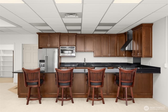 431 Airport Way SW, Mattawa, WA 99349 - kitchen with appliances with stainless steel finishes, wall chimney exhaust hood, dark countertops, a paneled ceiling, and a peninsula