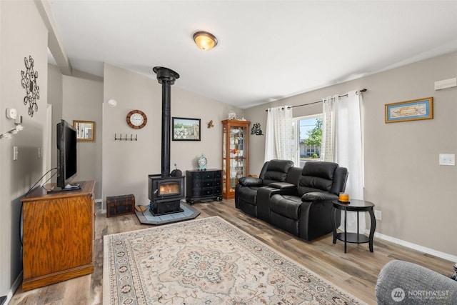 101 Shenandoah Dr, Silverlake, WA 98645 - living room with a wood stove, wood finished floors, and lofted ceiling