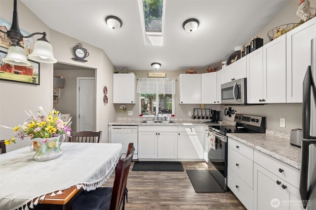 101 Shenandoah Dr, Silverlake, WA 98645 - kitchen with appliances with stainless steel finishes, white cabinets, dark wood finished floors, and a skylight