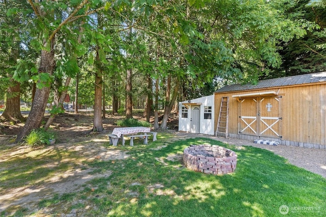 101 Shenandoah Dr, Silverlake, WA 98645 - view of grassy yard featuring an outdoor structure and a fire pit