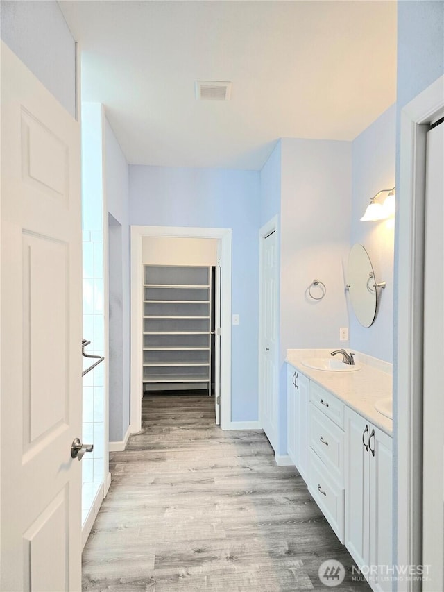 861 Willow Ct SW, Ocean Shores, WA 98569 - bathroom with double vanity, wood finished floors, and baseboards