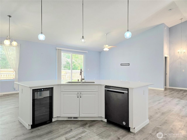 861 Willow Ct SW, Ocean Shores, WA 98569 - kitchen with dishwasher, wine cooler, a sink, light wood-style floors, and lofted ceiling