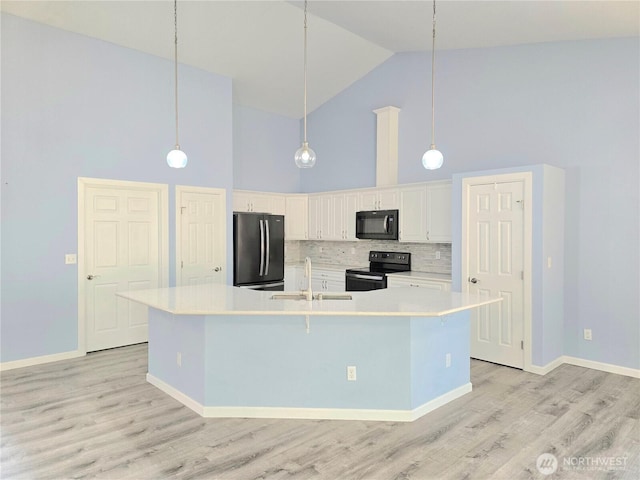 861 Willow Ct SW, Ocean Shores, WA 98569 - kitchen featuring black appliances, high vaulted ceiling, a sink, decorative backsplash, and light countertops