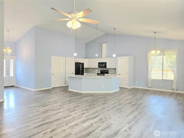 861 Willow Ct SW, Ocean Shores, WA 98569 - kitchen featuring black appliances, high vaulted ceiling, a chandelier, open floor plan, and white cabinetry