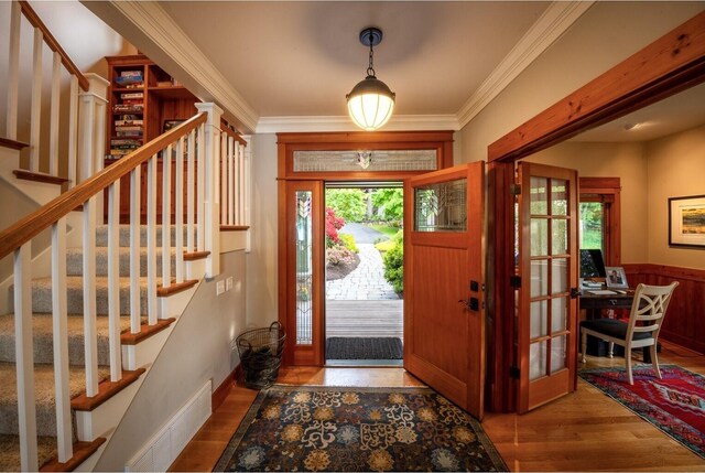 385 Sunset Ave, Orcas Island, WA 98245 - foyer entrance with stairway, wood finished floors, and ornamental molding
