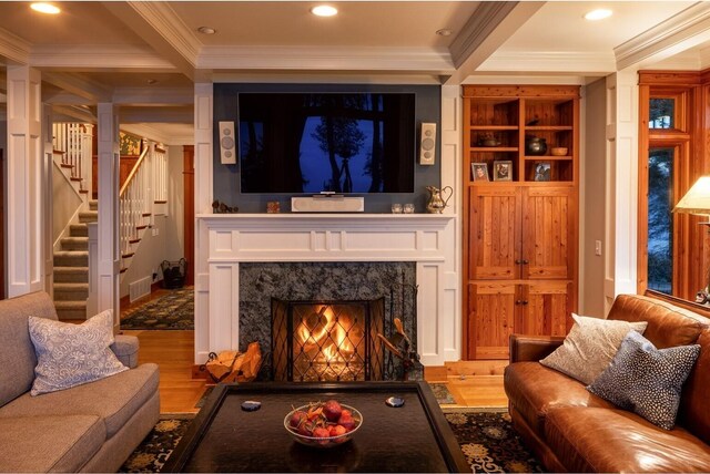 385 Sunset Ave, Orcas Island, WA 98245 - living room featuring crown molding, wood finished floors, a premium fireplace, stairway, and beam ceiling
