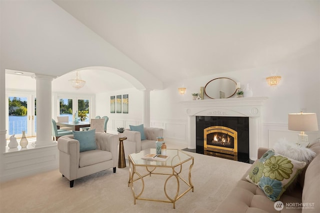 3604 Serene Way, Lynnwood, WA 98087 - living room with ornate columns, a decorative wall, arched walkways, light colored carpet, and vaulted ceiling
