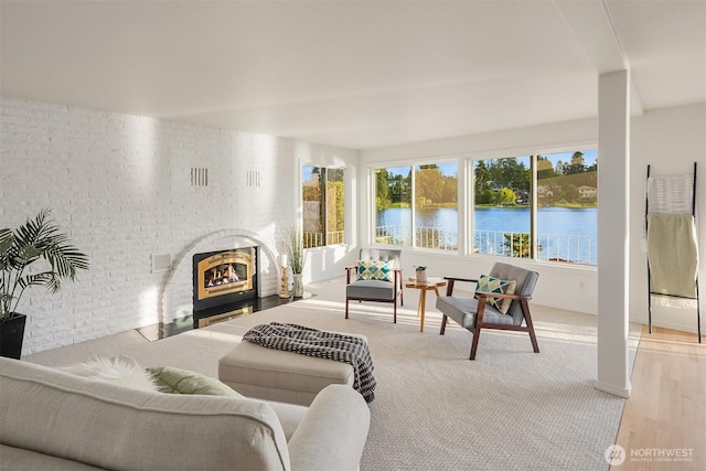 3604 Serene Way, Lynnwood, WA 98087 - living area featuring a brick fireplace, a water view, and carpet flooring