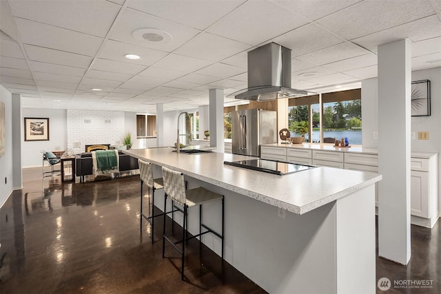 3604 Serene Way, Lynnwood, WA 98087 - kitchen featuring black electric stovetop, high end refrigerator, a drop ceiling, white cabinets, and island exhaust hood