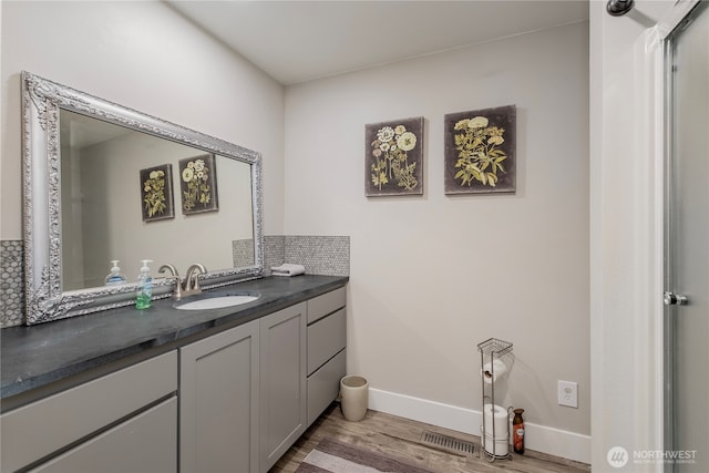 3418 Mari Lane Dr, Wenatchee, WA 98801 - bathroom with vanity, wood finished floors, and tasteful backsplash