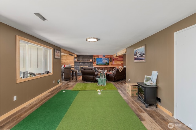 3418 Mari Lane Dr, Wenatchee, WA 98801 - living area with wood finished floors, wood walls, a fireplace, a wood stove, and an accent wall
